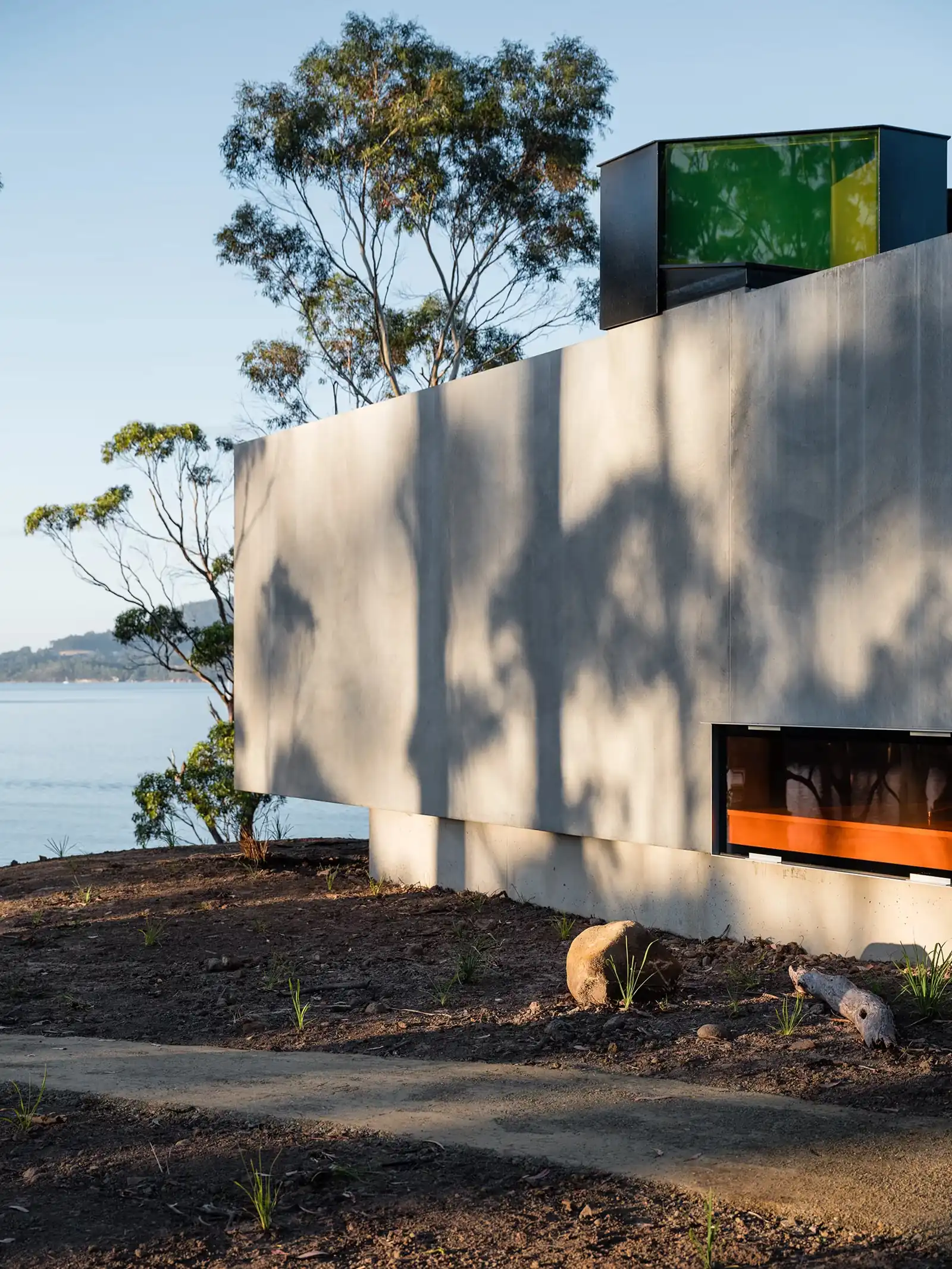 Concrete Vipp Tunnel cantilevered above the D'Entrecasteaux Channel, with coloured skylight glass on the roof