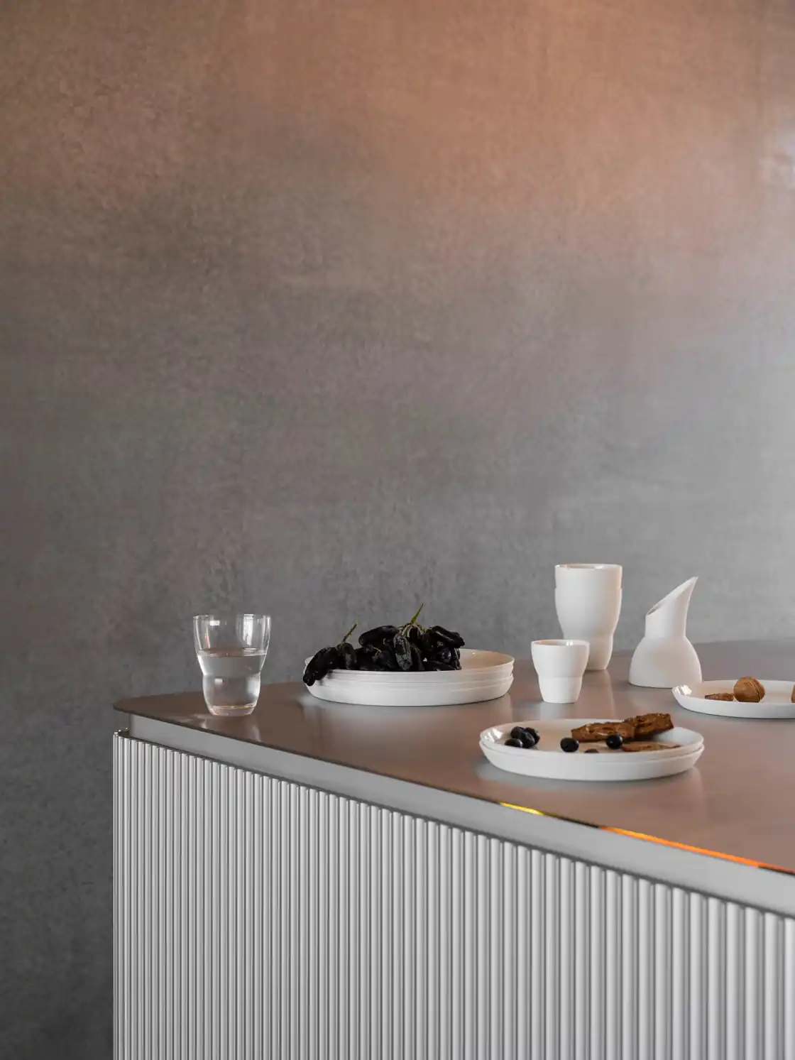 Vipp V3 kitchen with fluted aluminium doors and a stainless steel counter